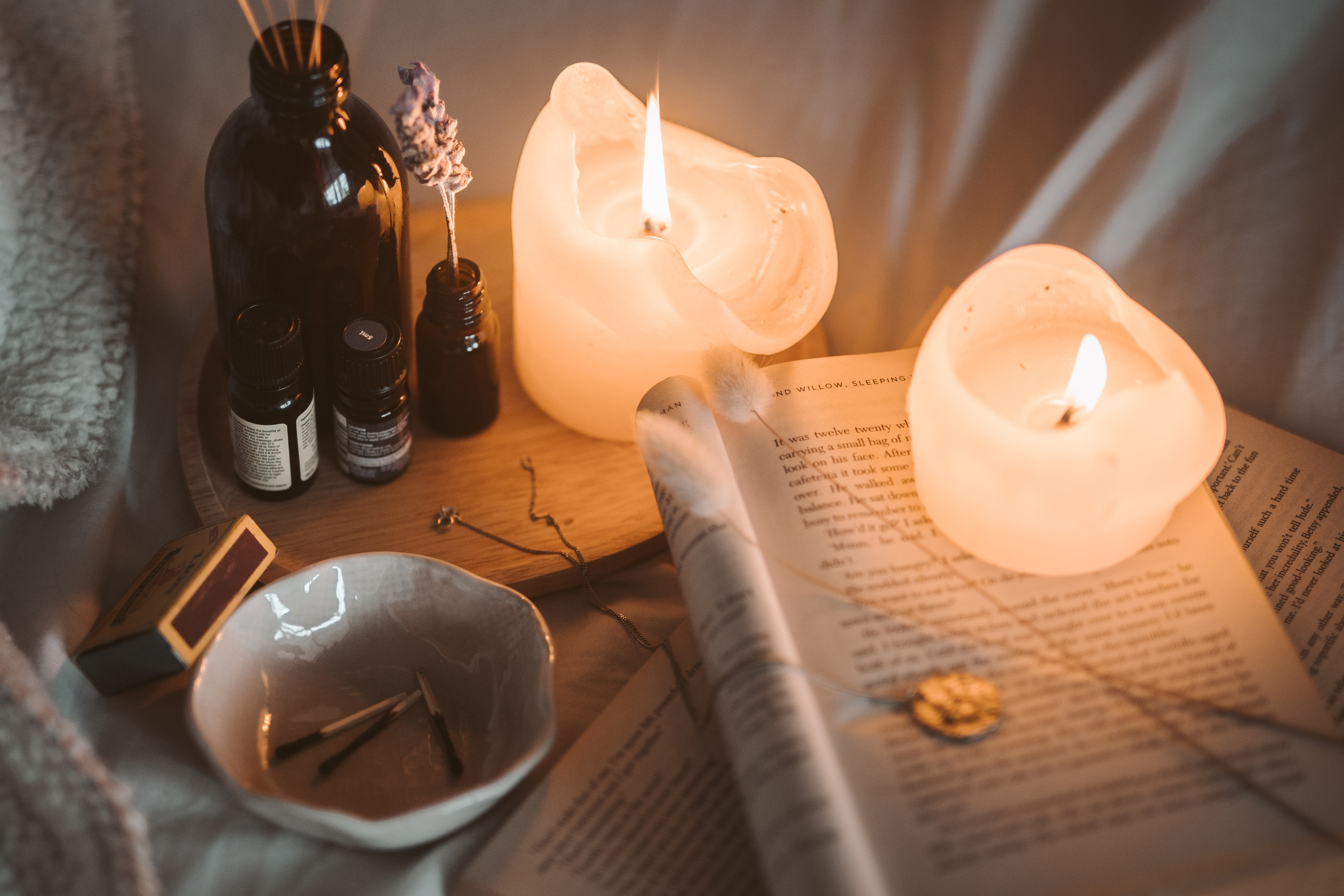 Picture of some candles with essential oils and a cup of tea.